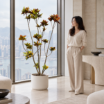 Croton | Large floor plant 大型植物置於半山低飽和輕奢家居人物觀賞場景，一位人物正在自然觀賞植物的情境示意圖 / Croton | Large floor plant styled in a Mid-Levels quiet-luxury home with an observer, with one person naturally observing it